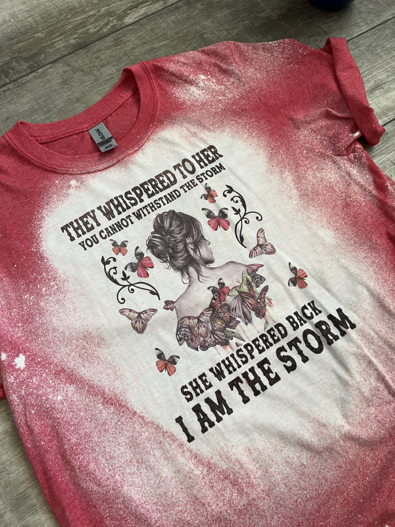 They whispered to her you cannot withstand the storm. She whispered back I am the storm red bleached tee