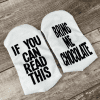 If you can read this bring me chocolate socks are printed on white socks on the bottom of the foot